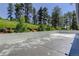 Large concrete patio with a view of the surrounding hillside and mature trees at 1688 Pine Valley Rd, Evergreen, CO 80439