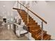 Modern staircase with wood treads and stainless steel railings, open to the living area at 1688 Pine Valley Rd, Evergreen, CO 80439