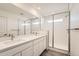 Main bathroom with double sinks, a large mirror and a shower at 1236 S Algonquian St, Aurora, CO 80018