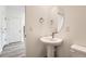 Small powder room with pedestal sink and oval mirror at 1236 S Algonquian St, Aurora, CO 80018