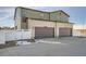 Two-car garage with modern doors and a white fence, attached to a two-story home at 1236 S Algonquian St, Aurora, CO 80018