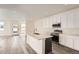 Modern kitchen with white cabinets, stainless steel appliances, and a large kitchen island at 1236 S Algonquian St, Aurora, CO 80018