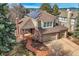 Expansive brick home featuring a three-car garage and solar panels at 7157 S Niagara Ct, Centennial, CO 80112