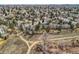 An aerial view captures a peaceful neighborhood bordered by a walking path and views of mature trees at 7157 S Niagara Ct, Centennial, CO 80112