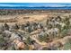 Aerial view showcasing homes in a wooded neighborhood with distant mountain views, highlighting the area's natural beauty at 7157 S Niagara Ct, Centennial, CO 80112