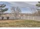 Lovely backyard with a well-maintained lawn, surrounded by a white fence and a picturesque view of open space at 7157 S Niagara Ct, Centennial, CO 80112