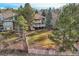 Expansive backyard featuring a large lawn, mature trees and a white picket fence, perfect for outdoor enjoyment at 7157 S Niagara Ct, Centennial, CO 80112