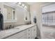 Dual vanity bathroom with marble countertops, lots of storage, and modern fixtures at 7157 S Niagara Ct, Centennial, CO 80112
