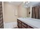 Traditional style bathroom with single vanity, tile floor and shower with curtain at 7157 S Niagara Ct, Centennial, CO 80112