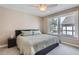 Cozy bedroom with ceiling fan, neutral colors and large windows at 7157 S Niagara Ct, Centennial, CO 80112