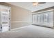 Bright room has a large window with plantation shutters and neutral walls at 7157 S Niagara Ct, Centennial, CO 80112