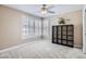 Bedroom with neutral carpet, large windows with shutters, and a ceiling fan at 7157 S Niagara Ct, Centennial, CO 80112