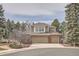 Attractive brick and siding home with a three-car garage and mature trees at 7157 S Niagara Ct, Centennial, CO 80112