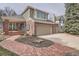 Charming brick home with a well-manicured lawn and a spacious three-car garage at 7157 S Niagara Ct, Centennial, CO 80112