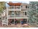 Backyard view of home featuring multiple levels of decks and patios for outdoor entertaining and relaxation at 7157 S Niagara Ct, Centennial, CO 80112