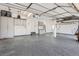 Spacious garage featuring ample storage cabinets, a clean epoxy floor, and abundant lighting for functionality at 7157 S Niagara Ct, Centennial, CO 80112