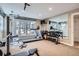 Well-equipped home gym featuring a treadmill, weight rack, and ample natural light for a healthy lifestyle at 7157 S Niagara Ct, Centennial, CO 80112