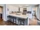 Bright kitchen featuring white cabinets, a tile backsplash, stainless appliances and an island with seating at 7157 S Niagara Ct, Centennial, CO 80112