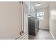 Functional laundry room with new washer and dryer, a refrigerator, white cabinets, and tiled floor at 7157 S Niagara Ct, Centennial, CO 80112