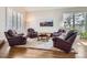 Cozy living room setup with four leather chairs around a central table on a soft rug at 7157 S Niagara Ct, Centennial, CO 80112