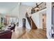 Elegant living room boasting hardwood floors and a grand staircase feature at 7157 S Niagara Ct, Centennial, CO 80112