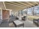 Relaxing covered patio with outdoor seating, ideal for enjoying the serene backyard views and fresh air at 7157 S Niagara Ct, Centennial, CO 80112