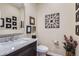 Well-decorated powder room with stylish fixtures, marble countertop, and decorative wall art at 7157 S Niagara Ct, Centennial, CO 80112