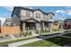 Charming townhome featuring a covered porch, low maintenance landscaping, and neutral exterior colors at 28330 E 6Th Pl, Watkins, CO 80137