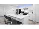 Bright kitchen boasts white cabinetry, stainless steel appliances, sleek countertops, and bar stool seating at 28330 E 6Th Pl, Watkins, CO 80137