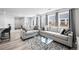 Spacious living room with large windows, modern sofas, stylish decor, and an open concept design at 28330 E 6Th Pl, Watkins, CO 80137