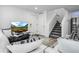 Bright living room featuring modern decor, neutral colors, and a flat screen television at 28330 E 6Th Pl, Watkins, CO 80137
