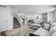 Open-concept living space including stairs to the upper floor, living room, kitchen, and dining area at 28330 E 6Th Pl, Watkins, CO 80137