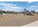 Community playground featuring swings, climbing structures, and a slide at 28330 E 6Th Pl, Watkins, CO 80137