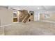 Finished basement area featuring carpet, a brick accent wall, access to bathroom, stairs, and storage at 3418 Elk Ct, Broomfield, CO 80020