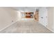 Spacious carpeted basement area featuring a built-in wet bar with sink, cabinetry, and a full-sized refrigerator at 3418 Elk Ct, Broomfield, CO 80020
