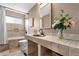 The bathroom features a tiled vanity, an undermounted sink, and modern fixtures at 3418 Elk Ct, Broomfield, CO 80020