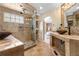 Modern bathroom boasting a glass shower, dual vanity, and tiled floors at 3418 Elk Ct, Broomfield, CO 80020