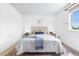 This bedroom boasts hardwood floors, a queen-size bed, and a view from the bright window at 3418 Elk Ct, Broomfield, CO 80020
