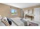 A tranquil bedroom featuring a window with views, a side table, and artwork at 3418 Elk Ct, Broomfield, CO 80020