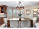 Charming dining area featuring a chandelier with views of the front yard and living room at 3418 Elk Ct, Broomfield, CO 80020