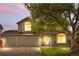 Two-story home featuring a well-maintained lawn, mature tree, and a two-car garage at 3418 Elk Ct, Broomfield, CO 80020