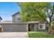 Charming two-story home featuring a well-manicured lawn, mature tree, and a two-car garage at 3418 Elk Ct, Broomfield, CO 80020