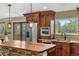 Kitchen boasts a breakfast bar, stainless steel appliances and window with views of the outdoor area at 3418 Elk Ct, Broomfield, CO 80020