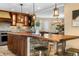 Gourmet kitchen with custom wood cabinets, stone island, and pendant lighting at 3418 Elk Ct, Broomfield, CO 80020