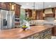 Beautiful kitchen featuring custom cabinets, stone countertops, stainless steel appliances, and stylish lighting at 3418 Elk Ct, Broomfield, CO 80020