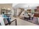 Open-concept living room with stylish decor, staircase, and natural light at 3418 Elk Ct, Broomfield, CO 80020