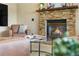 Inviting living room features a stacked stone fireplace and comfortable seating arrangements at 3418 Elk Ct, Broomfield, CO 80020