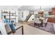 Open-concept living and dining area featuring hardwood floors, natural light and stairs at 3418 Elk Ct, Broomfield, CO 80020