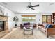 Spacious living room with stone fireplace, comfortable seating, and access to outdoor patio at 3418 Elk Ct, Broomfield, CO 80020