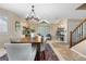 Bright living room with dining area featuring a chandelier and views of the front yard at 3418 Elk Ct, Broomfield, CO 80020